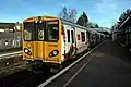 A Merseyrail Class 507 waits at the Liverpool-bound platform.