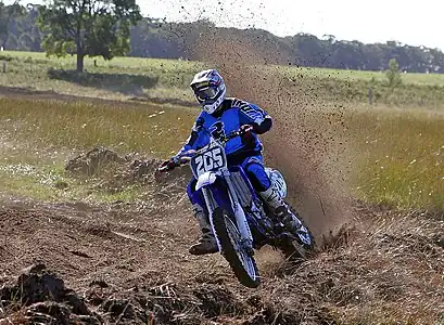 Image 20MotocrossCredit: Fir0002Motocross is form of motorcycle or ATV racing held on enclosed off-road circuits. The tracks are often quite large, natural, terrains with very few man made jumps, unlike Supercross, a sport that was originally derived from Motocross and is executed on a smaller track with many more extreme man made obstacles.More selected pictures