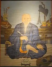 Portrait of Nguyễn Quý Kính, in the painting, Mr. Kính is holding a folding fan