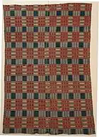 Medium blue, dark rose and beige coverlet composed of 2 panels and top and bottom have been hemmed by hand with large whip stitch; red, blue and black thread is used. In some places hem is coming out. Coverlet is very worn with several repairs, holes and frayed places
