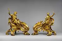 Pair of French Rococo andirons; circa 1750; gilt bronze; dimensions of the first: 52.7 × 48.3 × 26.7&nbsp;cm, of the second: 45.1 × 49.1 × 24.8&nbsp;cm; Metropolitan Museum of Art (New York City)
