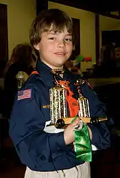 Image 33A happy Cub Scout holds a winning pine car