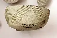 Fragment of pottery with incised and painted decor. From Tell Hassuna, 6500 - 6000 BCE.