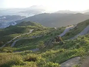 Rural road with many hairpin turns ascending a mountain