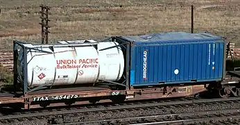 A spine car with a 20 ft tanktainer and an open-top 20 ft container with canvas cover