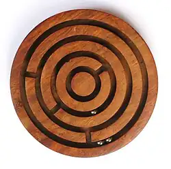 Image 19A ball-in-a-maze puzzle (from List of wooden toys)