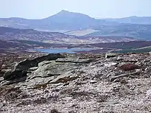 Schiehallion from Meall Dearg. Looking north-west from the stony plateau of Meall Dearg there is a good view of Schiehallion beyond Loch Hoil and the Tay valley.