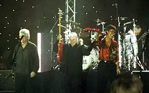 The Shadows performing in Denmark, featuring long time members from left Bruce Welch and (far right) Hank Marvin, Brian Bennett featured in background on drums.