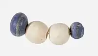 String of beads; 3650–3100 BC; lapis lazuli (the blue beads) and travertine (the white beads) (Egyptian alabaster); length: 4.5&nbsp;cm; by Naqada II or Naqada III cultures; Metropolitan Museum of Art (New York City)