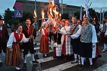 Image 6Estonian national clothes are a fine example of change in clothing after the industrial revolution. They changed a lot during 18th and 19th of century with the addition of new types of colors (like aniline dyes), placement of colors (like lengthwise stripes) and with the addition of new elements (like waistcoats). By the end of the 19th century they went out of use in most of the country (except more remote places as in Kihnu island) and it was only in mid 20th century when they once again gained popularity and now as a formal clothing. Members of University of Tartu Folk Art Ensemble wearing clothes specific to Kihnu island, Tori Parish (women in red skirts) and Tõstamaa area (men in brown clothing). (from History of clothing and textiles)