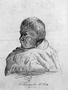 a pencil sketch of the head and shoulders of a man with tribal tattoos on his face. A cloak covers his shoulders