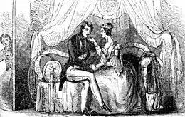 Victoria and Albert sitting on a sofa; Jones is present in the background, peering through a doorway