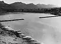 The 1,100 feet (340&nbsp;m) bridge over the Chindwin, in Burma, nearing completion in 1944. (The sections were constructed on a tributary and floated downstream on pontoons.)