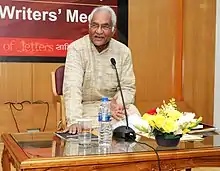 A photograph of a man sitting on the chair
