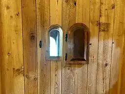 The leper window near the altar in the  Hopperstad Stave Church Replica allowed the individuals with Leprosy to see the service and receive communion while remaining outside of the church.