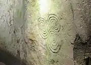 Decorated and cracked roof stone of the east side-chamber