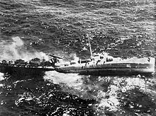 USS Fiske broken in two and sinking in the Atlantic Ocean on 2 August 1944 after she was torpedoed by the German submarine&nbsp;U-804. Note the men abandoning ship by walking down the side of her capsizing bow section.