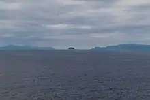 Umnak, Bogoslof and Unalaska Islands as seen from the Bering Sea looking south. Unalaska Island is on the left, Bogoslof Island is in the center, and Umnak Island is on the right.