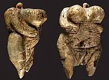 Two views of the Venus of Hohle Fels figurine, 40,000 BC-35,000 BC (6&nbsp;cm (2.4&nbsp;in) tall), one of the earliest known, undisputed examples of a depiction of a human being