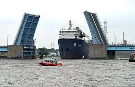 A large freighter passing through the Veterans Memorial Bridge on the Saginaw River