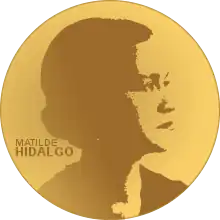 A golden medallion with an image of Matilde Hidalgo de Procel facing right in profile. To the left of the woman is the text "Matilde" then "Hidalgo"
